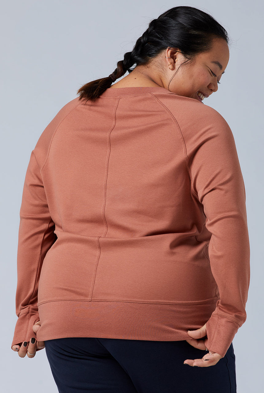 Woman wearing loungewear crewneck sweatshirt made from sustainable TENCEL and organic cotton in copper brown 4