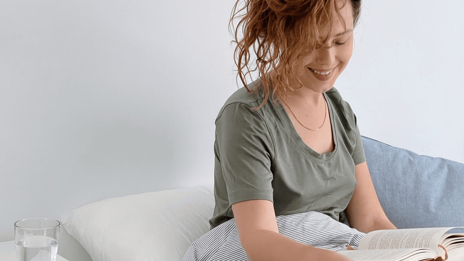 Woman sleeping in bed wearing pink pajamas sleepwear