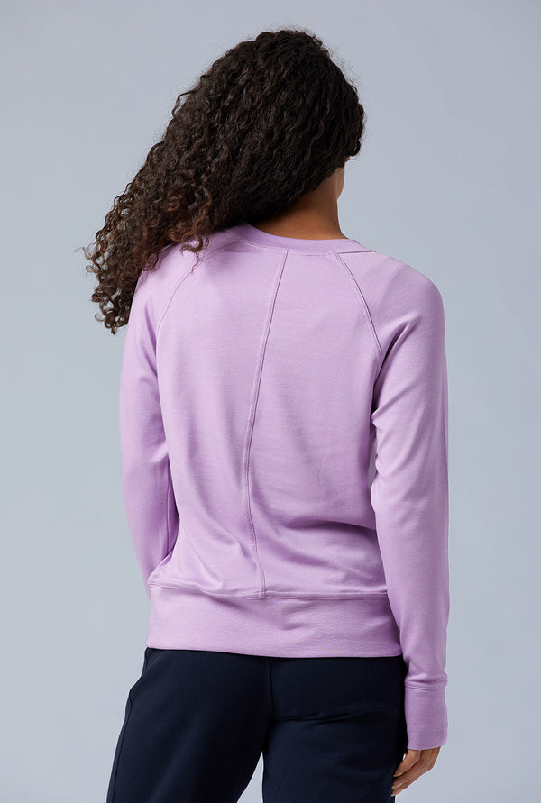 Woman wearing loungewear crewneck sweatshirt made from sustainable TENCEL and organic cotton in lilac 4