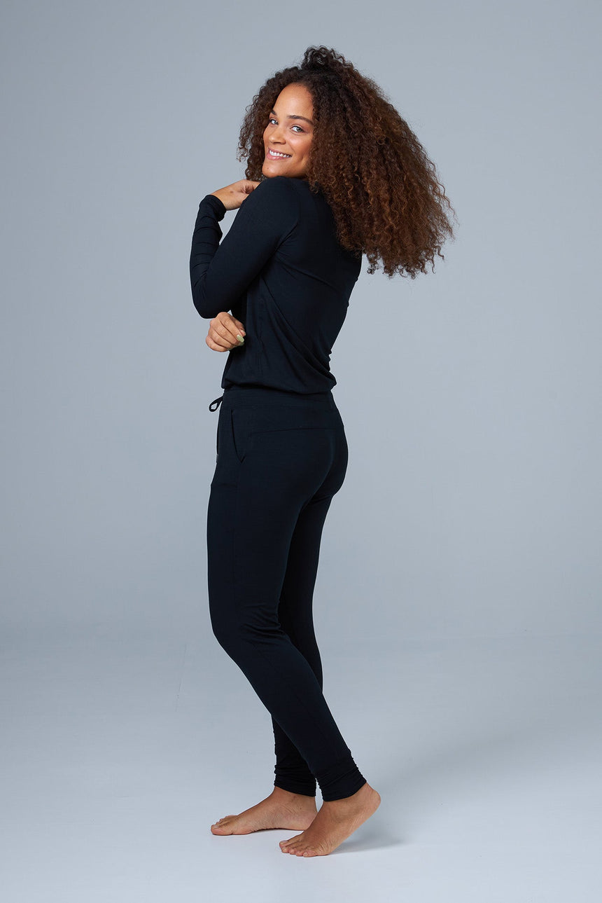 woman wearing black lounge pants and black sleep shirt side view