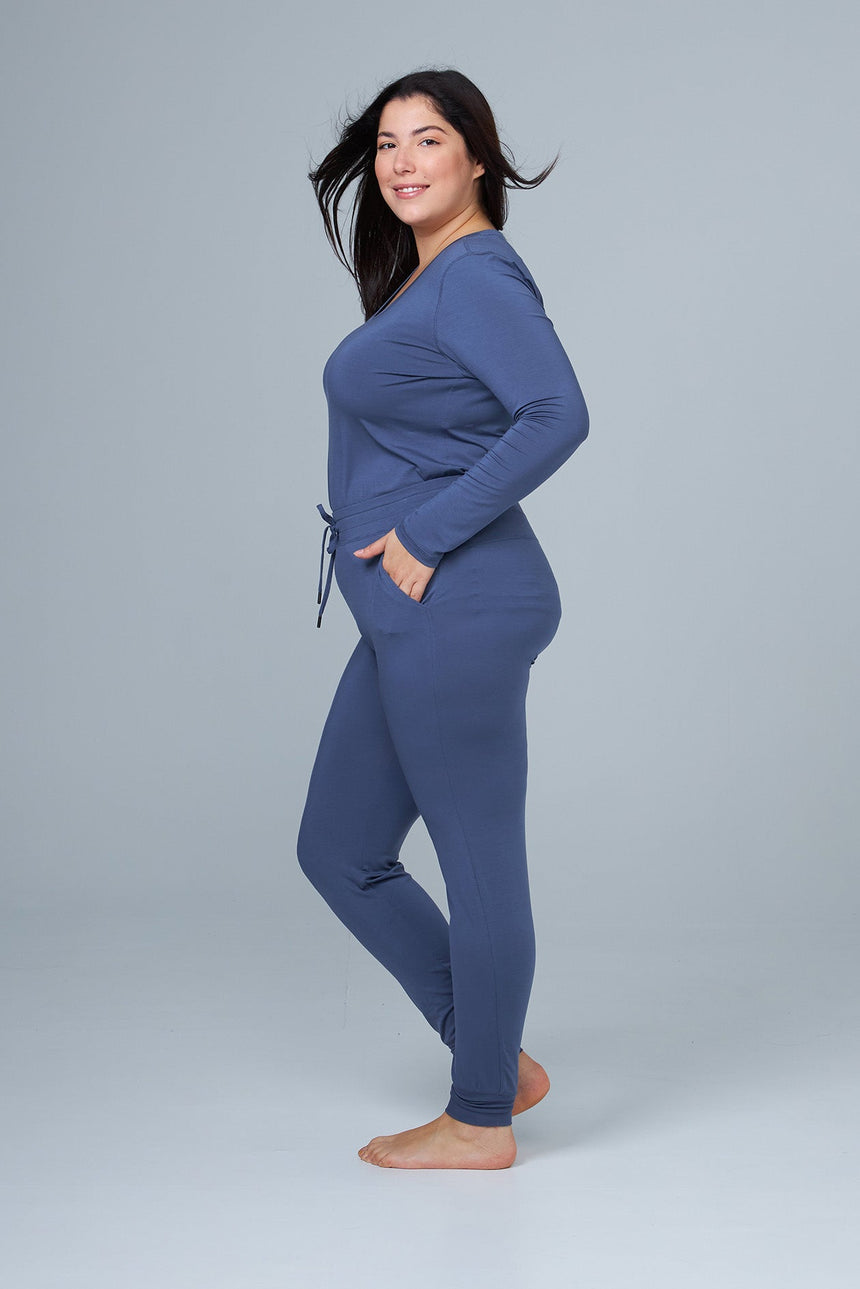 woman wearing blue lounge pants and blue sleep shirt side view