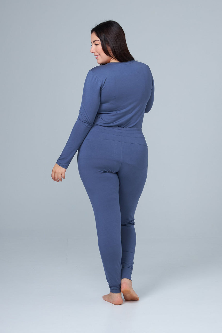 woman wearing blue lounge pants and blue sleep shirt back view