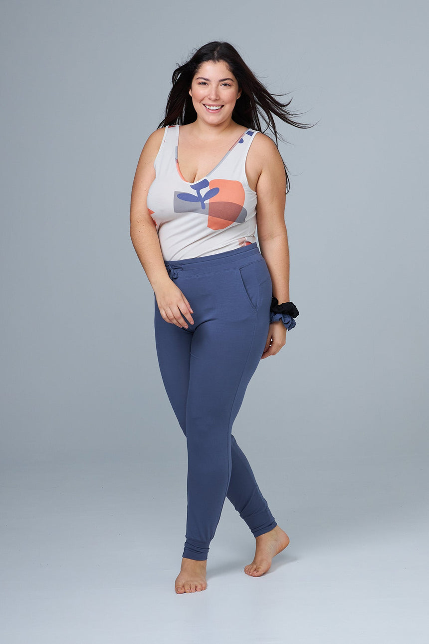 woman wearing blue lounge pants and print tank top