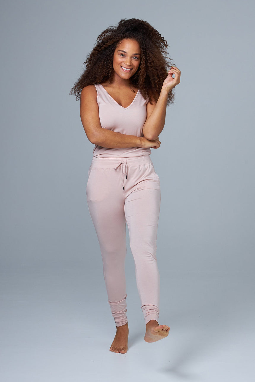 woman wearing pink lounge pants and pink tank top