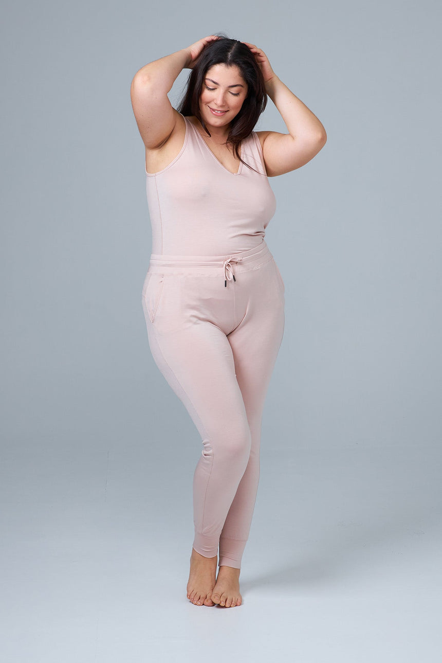 woman wearing pink lounge pants and pink tank top front view