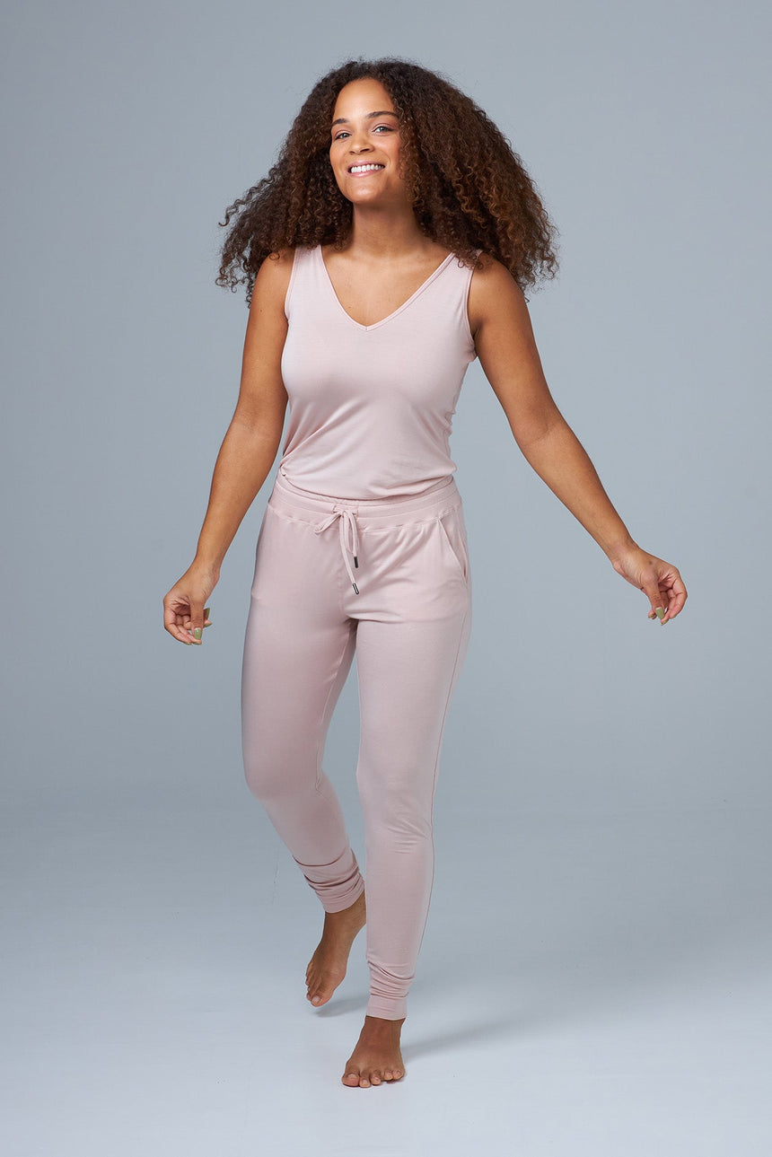 woman wearing pink lounge pants and pink tank top