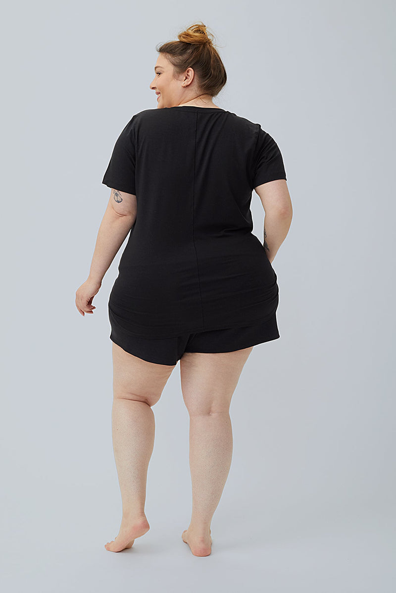 woman wearing black tencel cotton lounge shorts and black tshirt back view