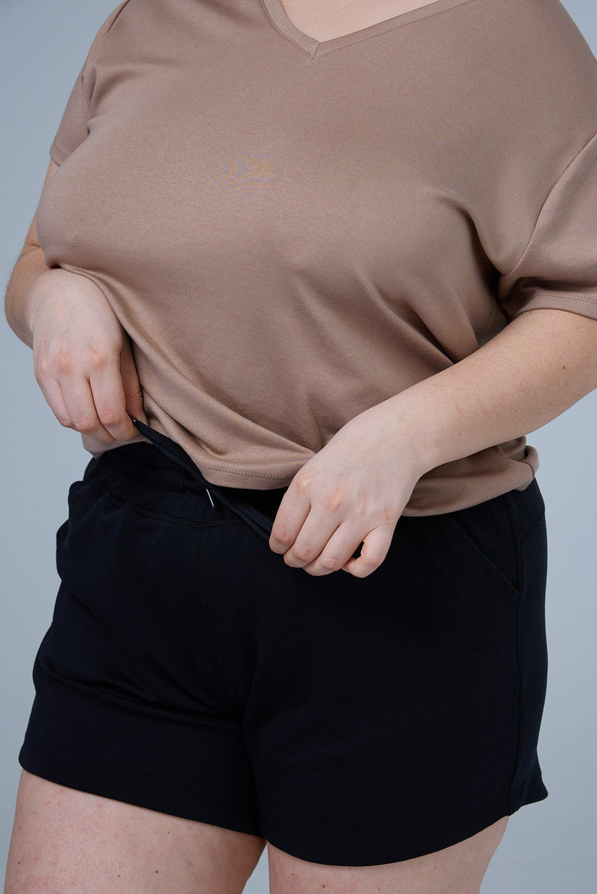 woman wearing black tencel cotton lounge shorts 