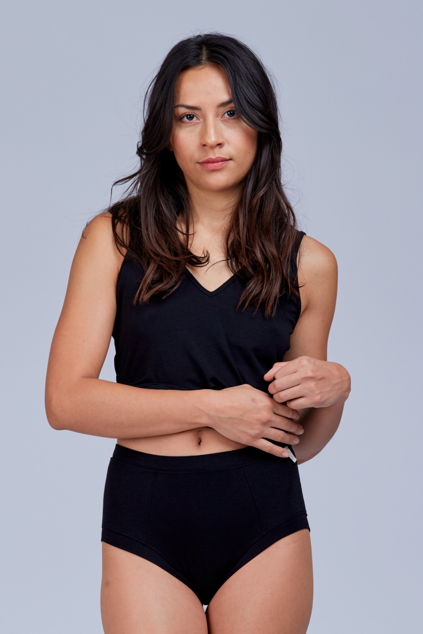 woman wearing black sleep shorts and black tank top front view
