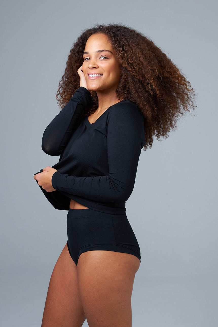 woman wearing black sleep shorts and black sleep top side view