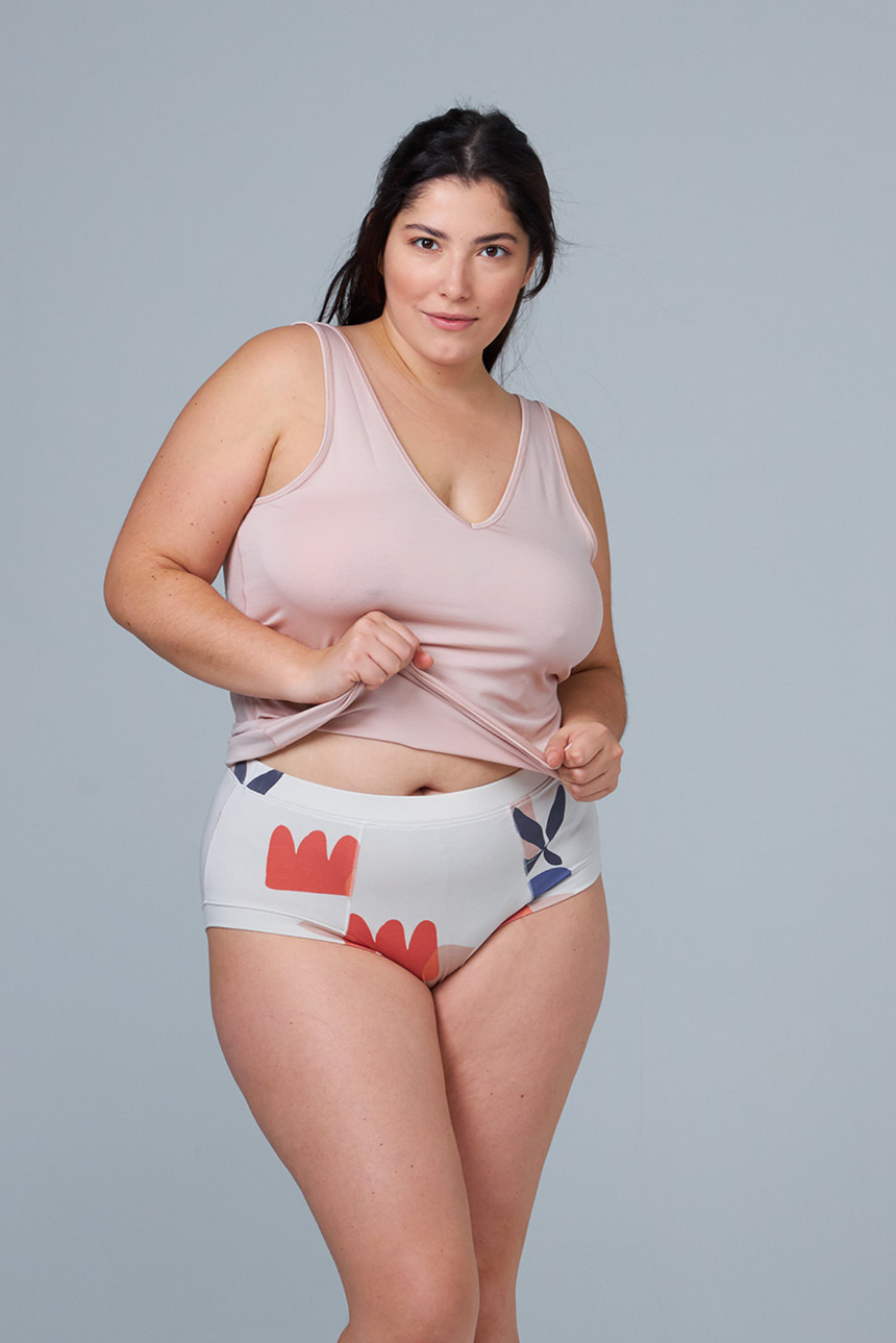 woman wearing multicolor sleep shorts and pink tank top