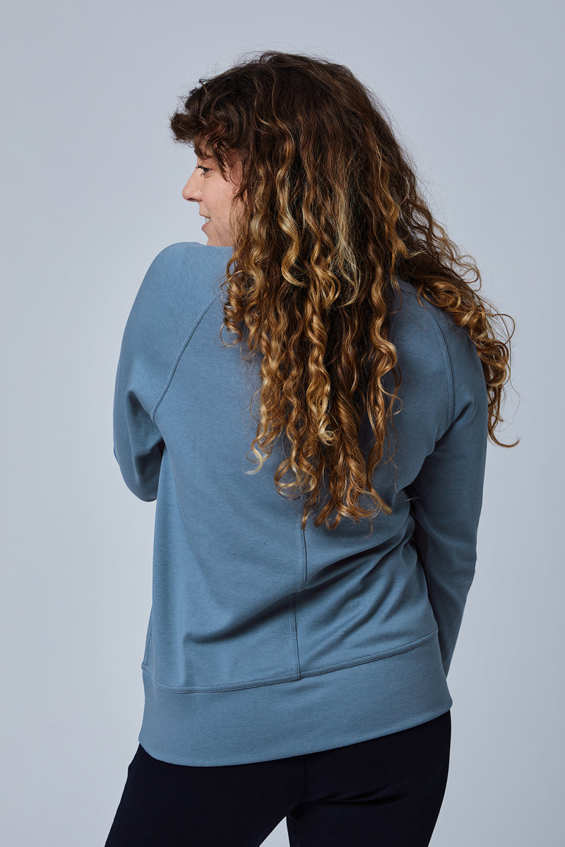 Woman wearing loungewear crewneck sweatshirt made from sustainable TENCEL and organic cotton in Coronet Blue - 7