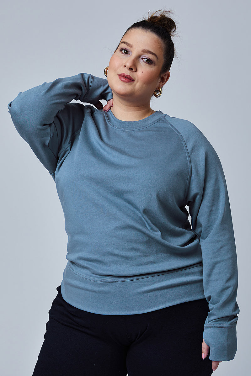 Woman wearing loungewear crewneck sweatshirt made from sustainable TENCEL and organic cotton in Coronet Blue -1 